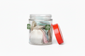Round glass storage jar 500ml with tea bags beside mug - kitchen tea jar with red lid Kenya